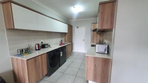 a kitchen with a washer and dryer in a room at The Blyde Crystal Lagoon One Bedroom Apartment in Pretoria