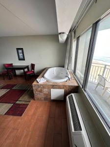 a bath tub in a room with a large window at Sandcastle Resort in Virginia Beach