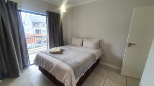 a bedroom with a bed with a phone on it at The Blyde Crystal Lagoon One Bedroom Apartment in Pretoria