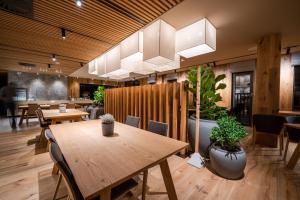 a restaurant with tables and chairs and a chandelier at Kapka resort in Vsetín