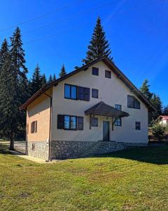 a large white house with a roof at Villa Grand Jahorina in Jahorina