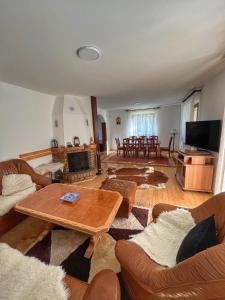 a living room with couches and a coffee table at Villa Grand Jahorina in Jahorina
