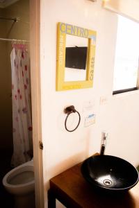 a bathroom with a black sink and a toilet at Hotel Miami SM in Santa Marta