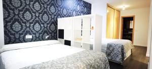 Cama o camas de una habitación en ALMAALQUILER Clavería 11