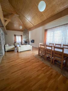 a large living room with a table and chairs at My sweet home Jahorina in Jahorina