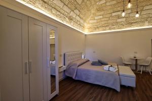 1 dormitorio con 1 cama y 1 mesa en una habitación en Dimora La Neviera, en Altamura