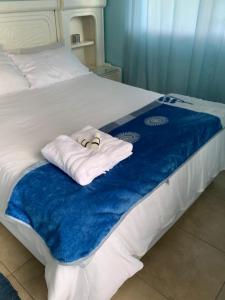 a bed with two towels sitting on top of it at Aqua on Newport street in Port Edward