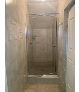 a shower with a glass door in a bathroom at Aqua on Newport street in Port Edward