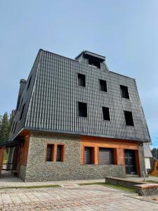 a building with a tin roof on top of it at My sweet home Jahorina in Jahorina