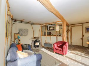 a living room with a blue couch and a fireplace at The DugOut in Hereford