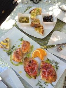 a table with plates of food on a table at Eco Sunshine Apartments Lumbarda in Lumbarda