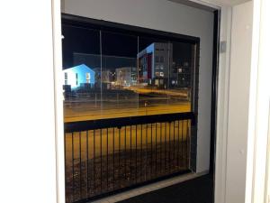 a window with a view of a city at night at Ihana huoneisto juna aseman vieressä. in Vantaa