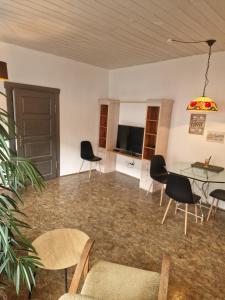 a living room with chairs and a table and a television at Ferienwohnung Wunderlich gelb in Münchberg