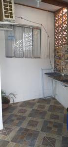 a kitchen with a counter top and a tile floor at Casa de Praia in Ilhabela
