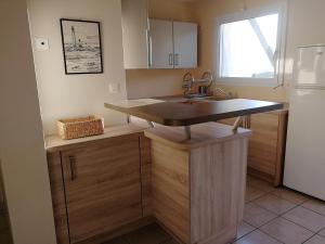 a kitchen with a sink and a refrigerator at Maison Aber Wrac'h in Landéda