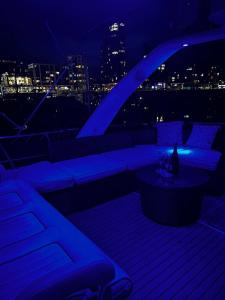 a balcony with a couch and a table at night at SUPERYACHT ON 5 STAR OCEAN VILLAGE MARINA, SOUTHAMPTON - minutes away from city centre and cruise terminals - free parking included in Southampton