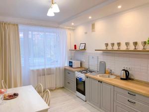 a kitchen with a sink and a stove top oven at Sunny Home in Oral