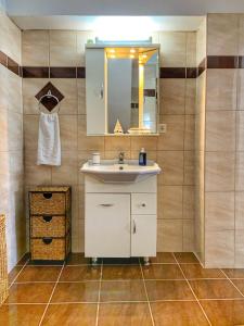 a bathroom with a sink and a mirror at Evaggelias Home Gavalochori in Gavalochori