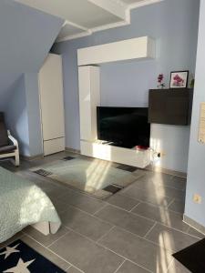 - une chambre dotée d'une télévision et de carrelage dans l'établissement Deluxe Apartment, à Wiesbaden