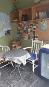 a table and chairs in a room with a tv at Fred&Donz Bed and Breakfast in Taupo