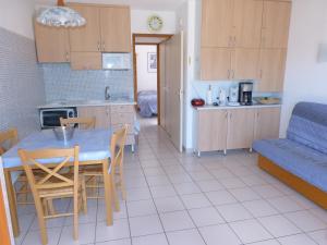 a kitchen and living room with a table and chairs at La Belledone à Vaujany in Vaujany