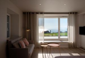 a living room with a couch and a large window at #Lavaux in Lutry