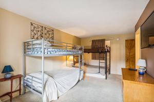 a bedroom with two bunk beds and a desk at Pinnacle E20 in Killington +15 photos