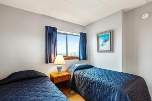a bedroom with two beds and a window at Pinnacle C10 in Killington +34 photos