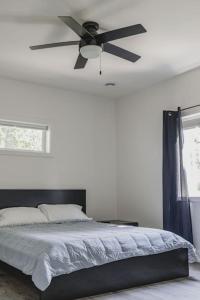 1 dormitorio con ventilador de techo y 1 cama en Shoreside 4b/4b walkout retreat with perfect sand, en Ottertail