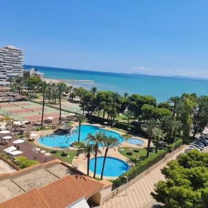 una vista aérea de dos piscinas junto al océano en Precioso apartamento en Cullera, con piscina junto a la playa, en Cullera