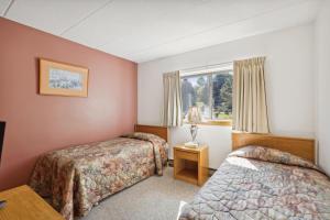 a hotel room with two beds and a window at Pinnacle E22 in Killington