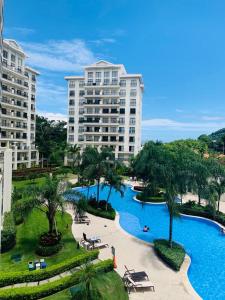 a resort with a swimming pool and two tall buildings at Luxury Condo Jaco Beach in Jacó