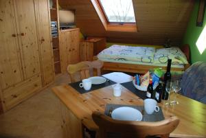 a room with a wooden table and a bed at Gästezimmer Anita in Schwabach