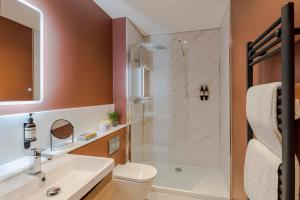 a bathroom with a shower and a toilet and a sink at Your Apartment I Milton Keynes in Milton Keynes