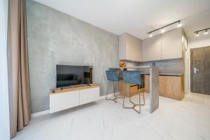 a kitchen with a bar with a tv and a counter at Style apartment studio Kabeny in Michalovce