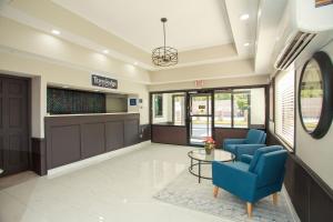 a waiting room at a hospital with blue chairs and a table at Travelodge by Wyndham Macon West in Macon
