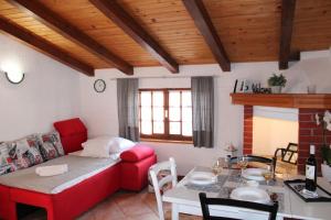 a living room with a red couch and a table at Lily's lovely apartments in Fažana