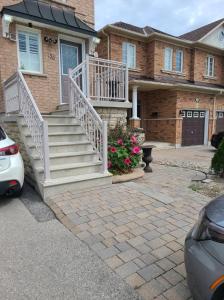 a brick house with stairs and flowers in the driveway at Top Floor of House in S Vaughan All to Yourself in Vaughan