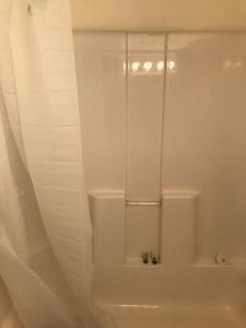 La salle de bains blanche est pourvue d'une douche et de toilettes. dans l'établissement Cozy Cottage House B with Double Carport, à Twin Falls