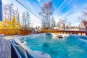 a hot tub on the deck of a house at Midtown Anchorage Basecamp Condo B in Anchorage