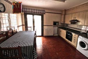 a kitchen with a sink and a table in it at Apartamento turístico Larraga in Monteagudo