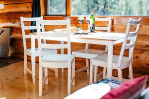 a white table and chairs in a room with a table at Rocky Mountain Escape Dome & Log Cabin Rentals - Rock Lake in Rock Lake Lodge Provincial Park
