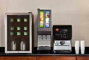 a coffee machine and a microwave on a counter at Days Inn by Wyndham San Antonio Near Fiesta Park in San Antonio