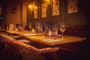 a long wooden table with wine glasses on it at The Bell in Solihull