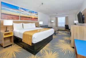 a hotel room with a bed and a flat screen tv at Days Inn by Wyndham Tunica Resorts in Tunica Resorts