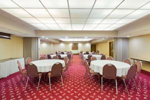 a conference room with tables and chairs and a podium at Best Western Braddock Inn in La Vale