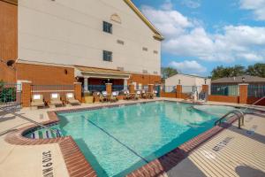 a pool at a hotel with chairs and a building at Best Western Plus Sweetwater Inn & Suites in Sweetwater