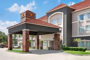 a hotel with a sign on top of it at La Quinta by Wyndham Brownsville North in Brownsville