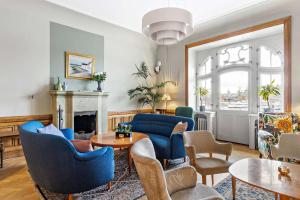 a living room with blue chairs and a fireplace at Hotel Esplanade; Sure Hotel Collection by Best Western in Stockholm