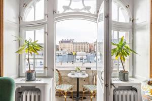 a room with a window and a table with plants at Hotel Esplanade, BW Signature Collection in Stockholm